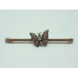 An early 20th Century diamond butterfly bar brooch, the insect having a millegrain set brilliant