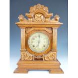 A late 19th Century American oak mantel clock by the New Haven Clock Co, having two-train movement