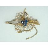 A 9ct gold, diamond, sapphire and seed pearl brooch, in an openwork floral arrangement, having a