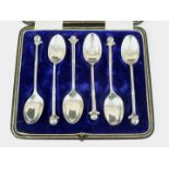 A cased set of six George V silver novelty teaspoons, the stems modelled as a trio of bound golf