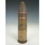 An inert British 37 mm artillery round bearing a printed paper label with legend Rendered in the