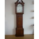 A late Georgian oak 30 hour long case clock by Blaylock of Carlisle, having an arched painted face