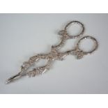A pair of Victorian silver sugar nips, cast in depiction of a fruiting vine, Maurice Freeman,
