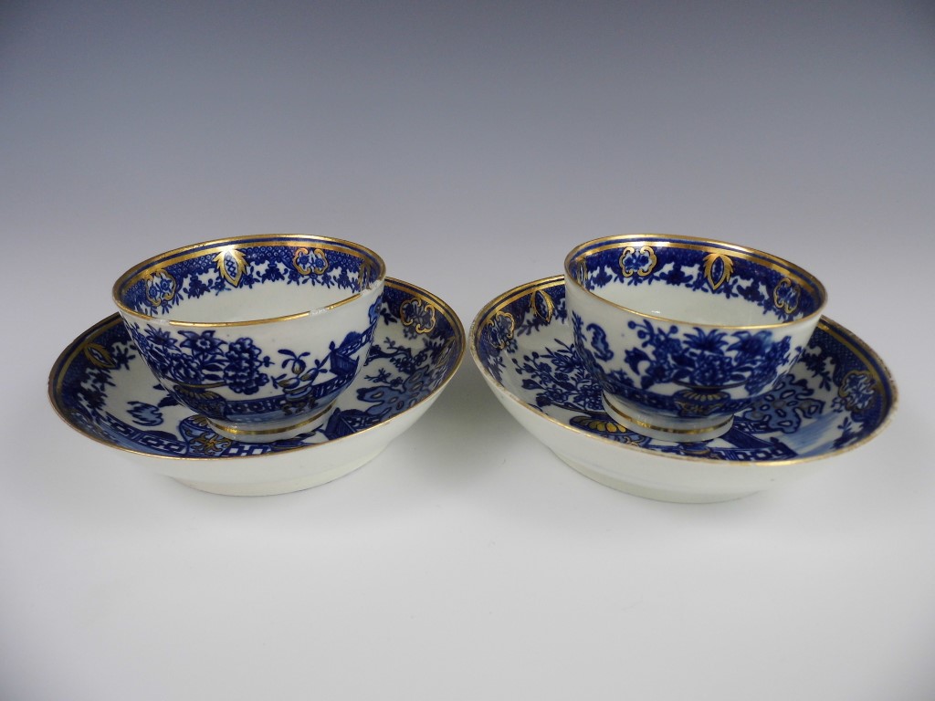 A pair of 18th Century Worcester blue and white transfer printed tea bowls and saucers in the Bat