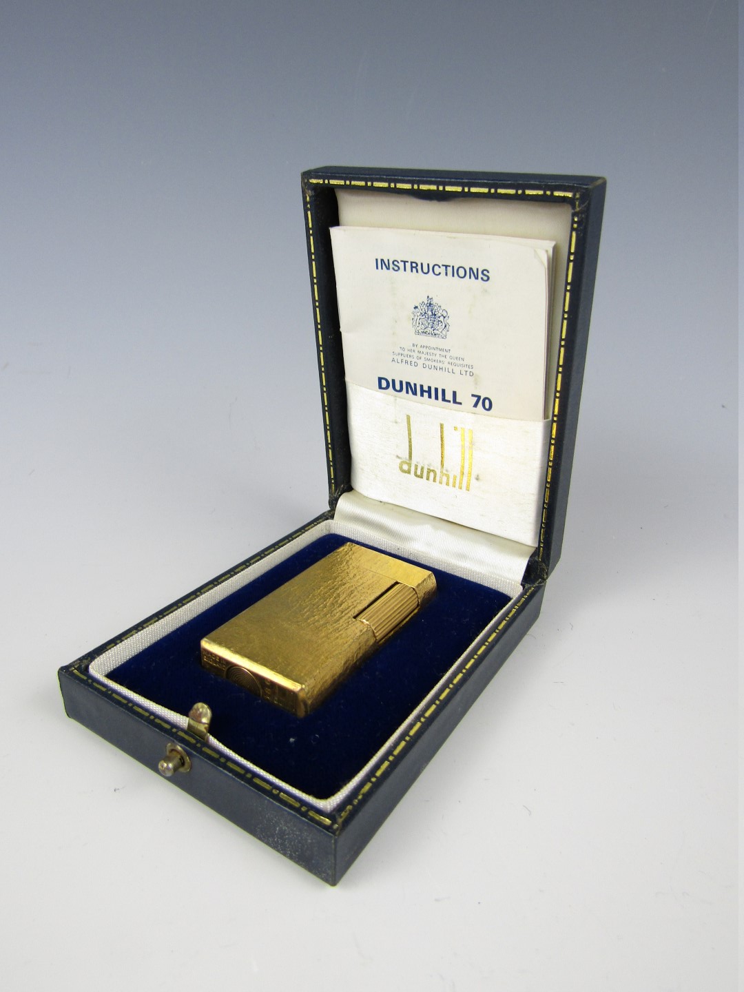 A Dunhill 70 gold-plated Rollagas lighter, in the 'subtle bark' pattern, with original case and