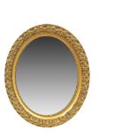 Carved and gilded wood mirror. Espejo oval en madera tallada y dorada con motivos de acantos y