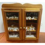 Miniature 2 door pine wall cabinet and large quantity of porcelain thimbles