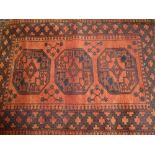 Afghan rug with triple gol design on a r