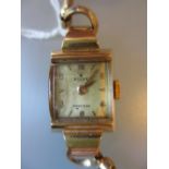 Ladies 9ct gold cased wristwatch on an expanding metal bracelet, movement by Rolex