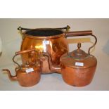 19th Century circular copper cauldron with iron handle together with two copper kettles