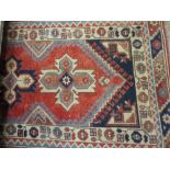 20th Century Turkish runner with repeating medallion design on a red ground with borders, 11ft x
