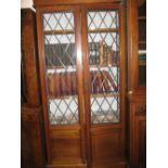 Edwardian mahogany display cabinet, the moulded cornice above leaded glass and panelled doors