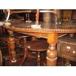 Early 20th Century oak oval wind-out extending dining table with single extra leaf and a set of