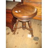 Beechwood piano stool with circular revolving seat on turned tripod base