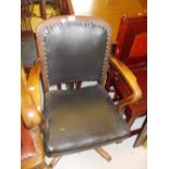 Early 20th Century oak swivel office chair and a circular oxidised copper framed wall mirror with