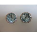 Pair of good quality 18ct white gold circular aquamarine and diamond ear clips housed in a Garrard