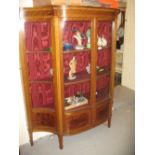 Edwardian mahogany and line inlaid serpentine shaped display cabinet raised on square tapering