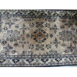 Indo Persian rug with stylised floral design on a fawn ground with borders, 176cms x 97cms