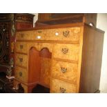 Mid 20th Century burr walnut kneehole desk with a plain top above a central cupboard surrounded by