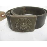 Third Reich leather belt with metal buckle embossed ' Gott Mituns ', with oak leaves surrounding an