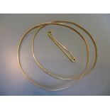 Two 18ct gold bangles and an 18ct gold tie clip