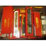 Four boxes containing a large collection of Hornby 00 and HO gauge model railways