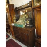 Arts and Crafts oak dresser, the mirrored back with embossed copper inserts, the base with two