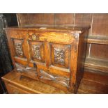 18th Century oak coffer bach, the hinged lid above three fielded panels and two drawers with plank