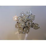 18ct White gold multiple diamond cluster ring in the form of a snowflake, approximately 1.30ct