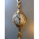 Ladies 9ct gold cased wristwatch by Rolex on a 9ct gold bracelet
