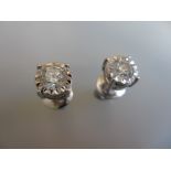Pair of 18ct white gold screw back diamond solitaire stud earrings, approximately 1.42ct