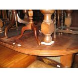 Small Victorian mahogany oval wind-out extending dining table on turned supports with two extra