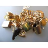9ct Gold charm bracelet with mainly 9ct gold charms