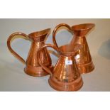 Graduated set of three early 20th Century beaten copper spirit measures