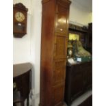 Early 20th Century oak tall narrow storage cabinet with a moulded cornice above four panelled doors