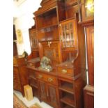 Late Victorian walnut bookcase / side cabinet having shaped and carved cornice above an arrangement