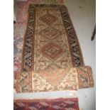 Hamadan runner with repeating pole medallion design on a fawn ground with borders, 14ft x 2ft 6ins