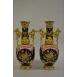 Pair of large Hungarian Zsolnay two handled pottery vases with floral relief moulded decoration