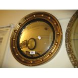 Circular gilded composition ball pattern convex mirror, an early 20th Century teak and brass