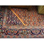 Large mid 20th Century Hamadan carpet with medallion and all-over Herati design on a red ground