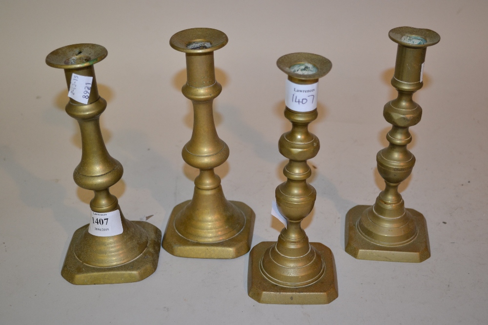 Two pairs of brass candlesticks