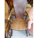 Arts and Crafts oak and elm open armchair having leatherette padded back raised on turned supports