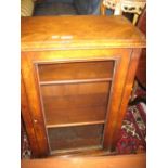 Victorian walnut music cabinet with single glazed panel door enclosing shelves above a plinth