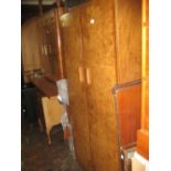 Walnut two door compactum wardrobe, similar two door wardrobe, a dressing table and a five drawer