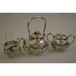 Late 19th or early 20th Century Chinese silver three piece tea service with tongs, relief moulded