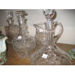 Two cut glass ships decanters, two other cut glass decanters and a similar jug
