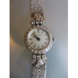 Ladies 18ct white gold and diamond set cocktail wristwatch, the champagne dial with baton numerals,