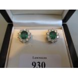 Pair of 18ct white gold oval emerald and diamond cluster stud earings, the emeralds approximately