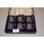Cased set of six Chester silver glass holders (one glass missing)