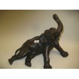 20th Century bronzed composition figure of a reclining elephant, 14.5ins high, 17ins wide